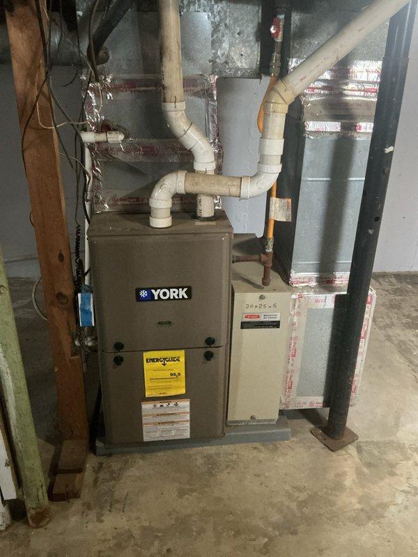 Completed on-site evaluation for adding air conditioning system to existing heating-only setup. Assessed current YORK furnace installation in basement and existing ductwork configuration to determine compatibility and requirements for AC integration. Documented existing equipment specifications and thermostat setup to provide comprehensive estimate for central air conditioning addition.