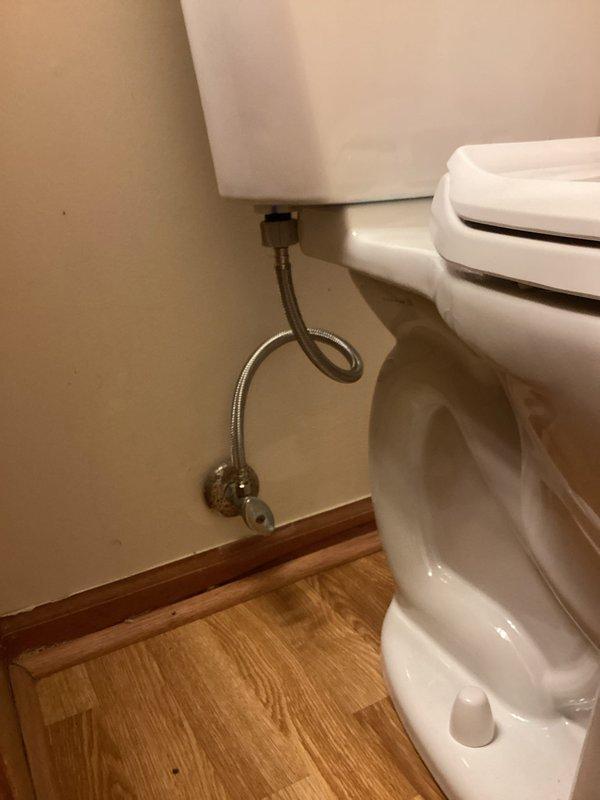 Installed customer-supplied toilet on main floor bathroom. Removed existing fixture, set new two-piece toilet onto hardwood flooring, secured unit to flange, and connected water supply line with braided stainless steel flex line to wall-mounted shut-off valve. Tested for proper operation and verified no leaks at all connection points.