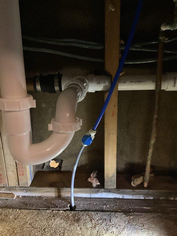 Returned to property to access previously identified leak locations in bathroom and kitchen areas. Opened wall and ceiling cavities to expose plumbing systems for repair work. Inspected and repaired leaking connections on PVC drain assemblies beneath fixtures, including P-trap installations and horizontal drain lines. Accessed crawl space and attic areas to address leaking pipes running through structural framework, repairing compromised joints and fittings on both horizontal and vertical PVC drainage systems. Secured all repaired plumbing connections and verified proper drainage flow with no active leaks present upon completion.
