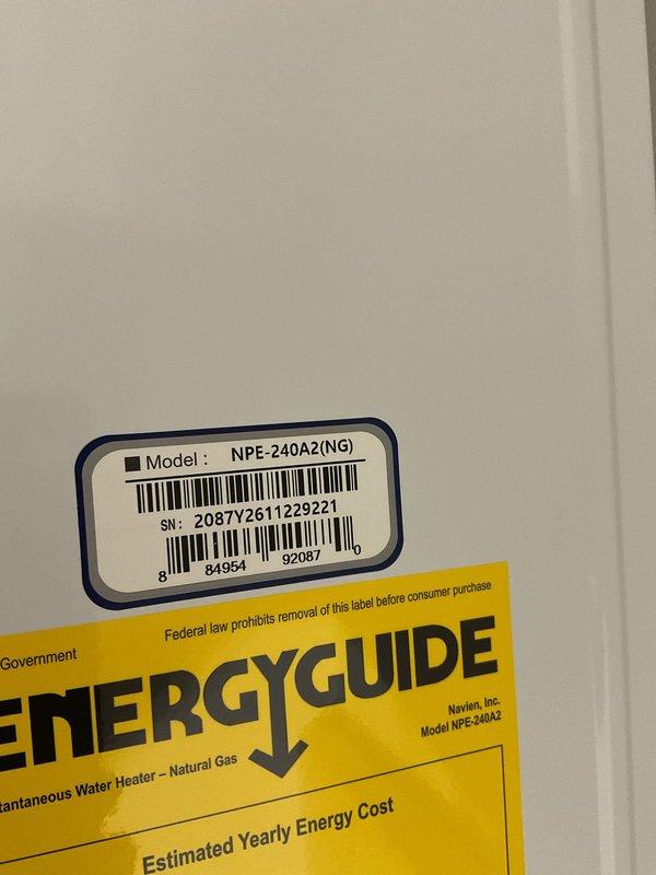 Completed full installation of Navien NPE-240A2 tankless natural gas water heater. Ran new gas line from existing supply, routed flue pipe to exterior for proper venting, and installed water supply and drain lines to unit specifications. Unit mounted securely to wall with all connections properly configured and tested for safe operation.