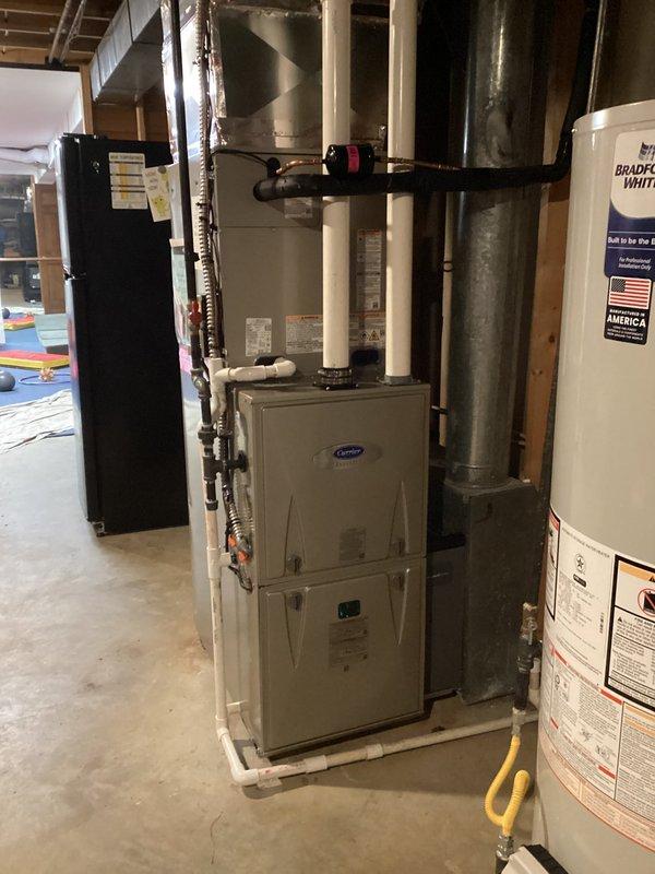 Completed full HVAC system replacement in basement mechanical room, installing Carrier Infinity Series variable-speed air conditioner (26VNA136W003), 98% AFUE modulating gas furnace (59MN7C080C17--14), evaporator coil (CVAVA4217XMA), and Infinity System Controller with WiFi capability (SYSTXCCITC01-C). Removed and recycled existing equipment, reconnected to existing line set with complete flush and pressure test to ensure refrigerant system integrity. Installed new electrical disconnect and whip, ran PVC condensate drainage, and integrated all components into communicating system architecture. Configured thermostat with full system programming and provided operational training. Registered all equipment warranties and obtained required permits. Senior technician performed post-installation quality assurance inspection and system performance verification.