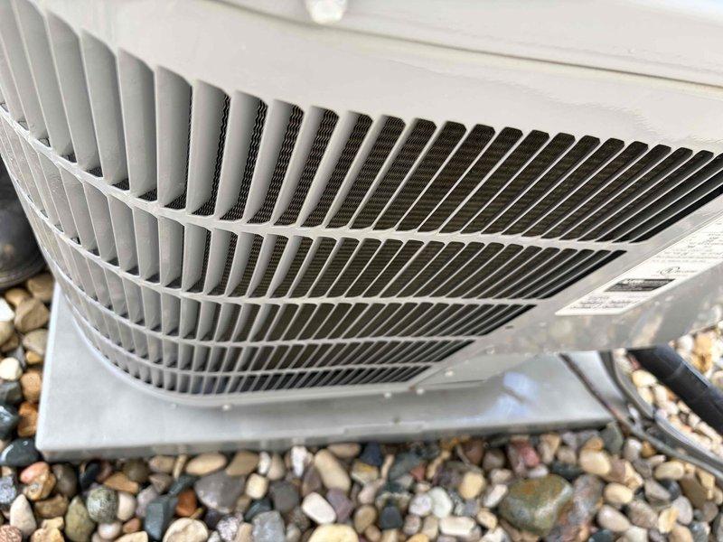 Completed comprehensive air conditioning tune-up service on outdoor condensing unit. Performed electrical diagnostics using clamp meter, measuring capacitance at 33.69 μF to verify proper compressor and fan motor operation. Inspected condenser coil through fan grille, confirmed unit cleanliness, verified proper airflow, and ensured all components were functioning within normal operating parameters.
