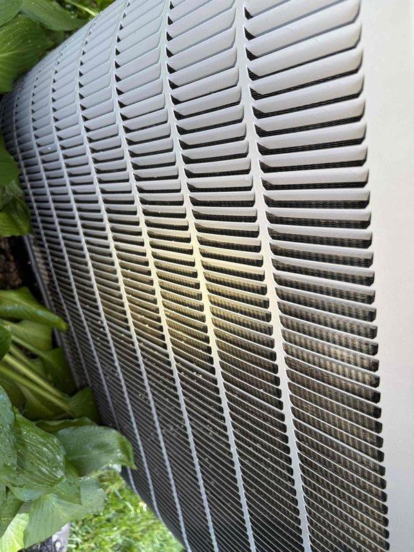 Completed first preventative maintenance visit on residential air conditioning system under maintenance agreement expiring May 2027. Inspected outdoor condensing unit, noting visible dirt accumulation and environmental staining on lower portion of unit grille requiring attention during future service intervals. Documented equipment condition with photos showing exterior ventilation components and grille assembly. Customer notified technician is en route as requested and has separately scheduled heating system maintenance visit.