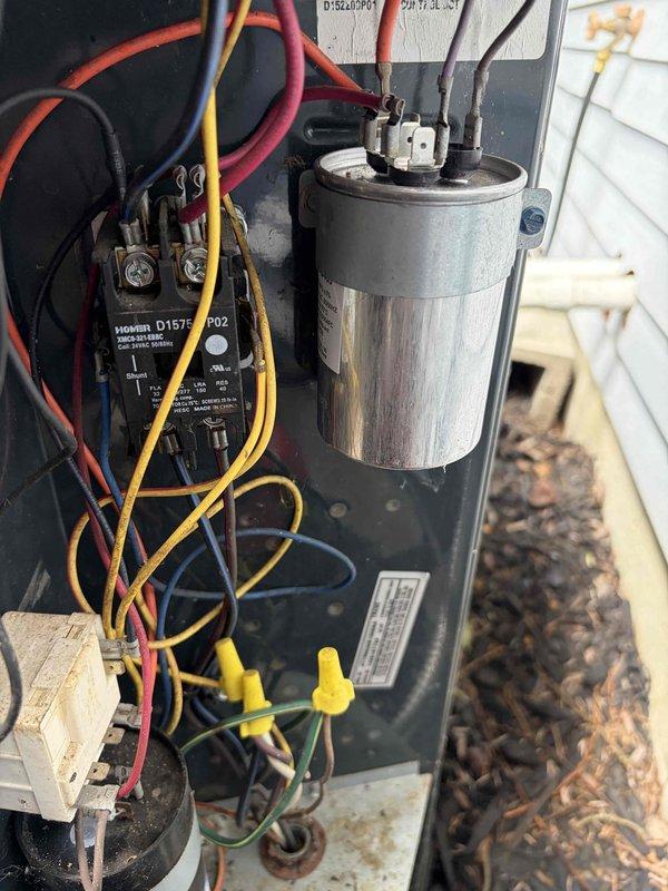 Completed first prepaid cooling season maintenance visit on residential air conditioning system. Performed comprehensive inspection of outdoor condensing unit including visual assessment of cabinet condition, electrical connections, and capacitor. Verified proper operation of contactor relay and examined all wire terminations for secure connections. Unit found in functional condition with normal weathering consistent with outdoor installation. Documented system components and electrical panel configuration with photographs for service records.