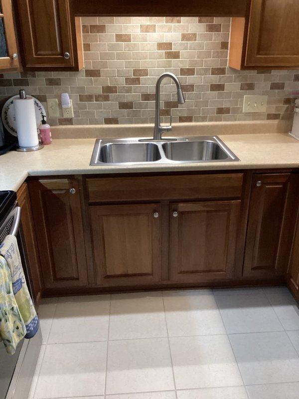 Picked up two spigot rebuild kits from vendor as previously ordered and completed installation of Moen Model 87069SRS faucet components in kitchen sink. Both spigot assemblies were successfully rebuilt and tested for proper operation, with no leaks detected upon completion.