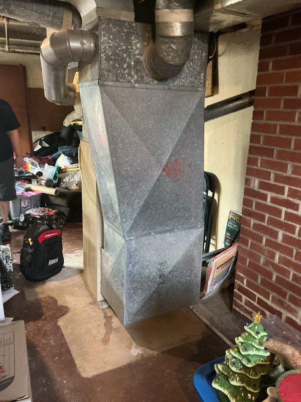 Conducted on-site evaluation of non-functional air conditioning system in residential basement that has been inoperative for approximately two years. Assessed existing HVAC equipment including air handler unit with connected plenum and ductwork distribution system. Documented current system configuration and conditions to provide replacement estimate for new AC unit installation in preparation for property sale.