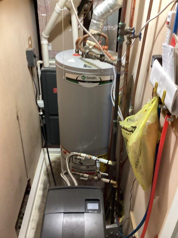 Conducted on-site assessment of existing A.O. Smith tank-style water heater installation located in utility closet to provide estimate for tankless water heater replacement. Evaluated current plumbing configuration including copper water supply lines, PVC venting system, and available space constraints within the mechanical room shared with HVAC equipment. Documented existing installation setup and discussed tankless water heater options with homeowner to determine appropriate sizing and installation requirements for future replacement.