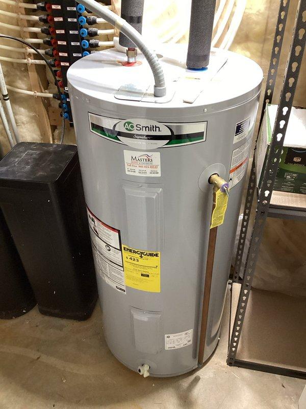 Responded to service call for electric tanked water heater with reported seepage from top connections. Upon inspection of the A.O. Smith unit located in basement, identified minor leak at hot water outlet connection. Inspected and removed anode rod to assess internal tank condition and corrosion protection status. Anode rod showed moderate deterioration consistent with unit age. Performed complete tank flush to remove sediment buildup and improve heating efficiency. Tightened top connection fittings and verified all plumbing connections for proper seal. Tested unit operation following service and confirmed no active leaks present. Provided recommendations for ongoing maintenance schedule.