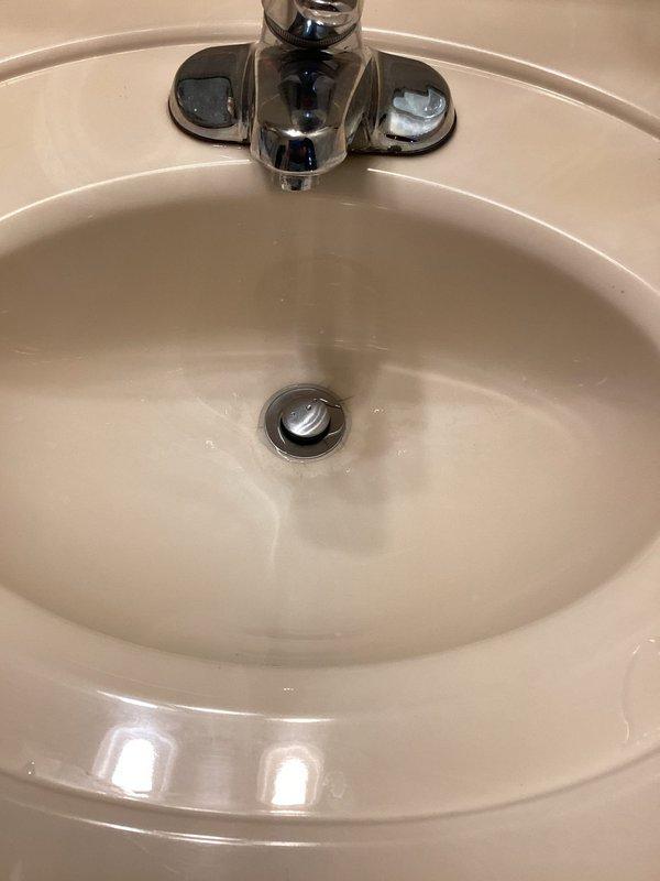 Completed scheduled plumbing service at residential property involving bathroom sink fixture work. Serviced chrome faucet assembly with dual handle controls and drain stopper mechanism, ensuring proper operation and water flow. Total service time approximately two hours as estimated.