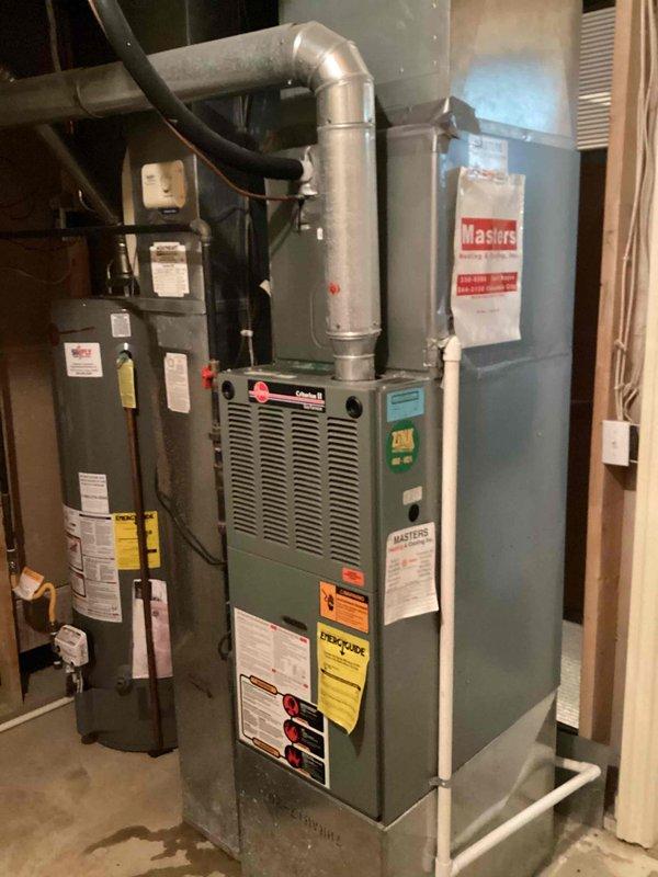 # HVAC Service Call - No Cooling

Responded to service call for 26-year-old Goodman air conditioning system with complete loss of cooling and no system operation. Upon arrival, performed comprehensive diagnostic evaluation of entire HVAC system including furnace, air handler, and associated components.

Conducted visual inspection of equipment in basement mechanical room, noting age and condition of existing Goodman furnace unit and connected ductwork. Examined electrical connections, control wiring, and power supply to determine cause of system failure. Inspected refrigerant lines, ductwork connections, and insulation in ceiling area for signs of damage or deterioration.

Evaluated system specifications using manufacturer labels and documentation affixed to equipment. Assessed water heater proximity and clearances to HVAC components. Photographed equipment configuration and installation details for service documentation.

Given the advanced age of the 26-year-old system, discussed sys
