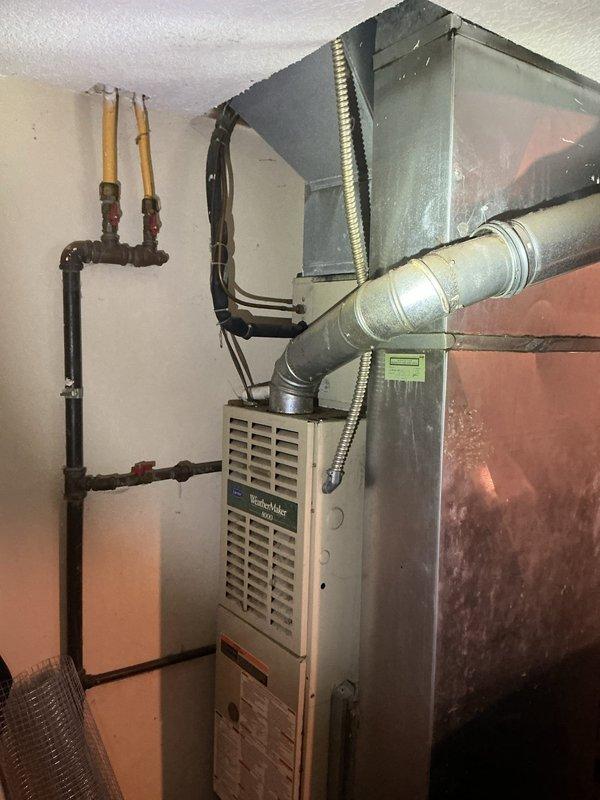 Conducted on-site evaluation of residential HVAC system for replacement estimate after air conditioning failure from previous year. Inspected existing basement furnace installation, ductwork configuration, gas line connections, and electrical components. Documented current equipment specifications and measured existing unit dimensions to provide accurate replacement system recommendations.