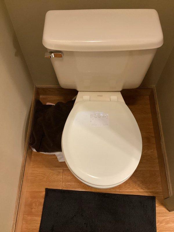Responded to service call for toilet evaluation and potential replacement. Upon arrival, inspected residential bathroom toilet fixture, including tank assembly, flush mechanism, and bowl condition. Assessed toilet's operational status and determined appropriate course of action based on findings. Documented existing conditions with photographs showing standard white porcelain tank-style toilet with chrome flush lever and overall bathroom configuration.