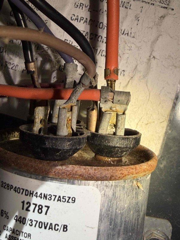Completed prepaid cooling system maintenance inspection on residential air conditioning unit. Performed comprehensive system evaluation including electrical component testing, verified capacitor operation and voltage readings using digital multimeter, and inspected all electrical connections and terminals. Noted visible corrosion on capacitor terminals and documented system specifications for maintenance records, with unit operating within normal parameters at time of service.