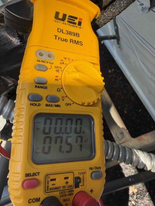 Completed prepaid cooling system maintenance inspection on residential air conditioning unit. Performed comprehensive system evaluation including electrical component testing, verified capacitor operation and voltage readings using digital multimeter, and inspected all electrical connections and terminals. Noted visible corrosion on capacitor terminals and documented system specifications for maintenance records, with unit operating within normal parameters at time of service.