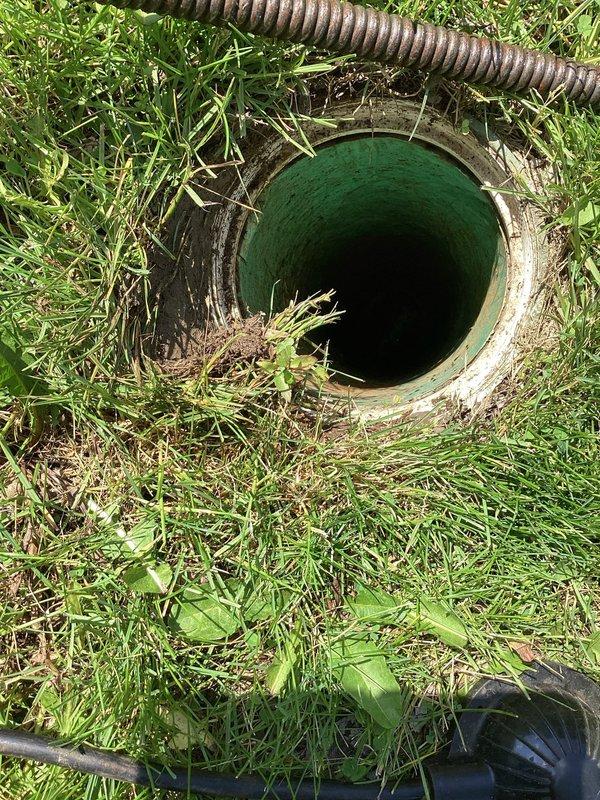 Responded to service call for downstairs toilet blockage. Upon arrival, accessed exterior cleanout to snake main drain line servicing the affected fixture. Cleared obstruction using power auger equipment through ground-level access point, restoring proper drainage flow to the toilet. Verified successful clearance and proper operation upon completion.