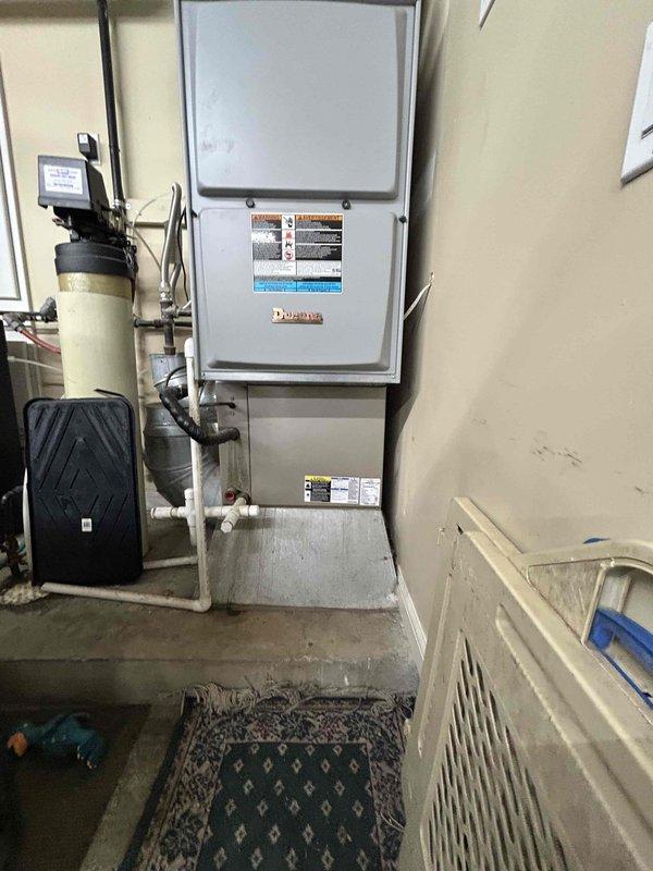 Completed estimate for replacement of air conditioning system and evaporator coil. Assessed existing indoor furnace unit located in garage and outdoor condensing unit, noting mismatched equipment ages between coil and outdoor unit. Documented current system configuration with both indoor and outdoor components, provided replacement recommendations, and photographed existing equipment for proposal documentation.