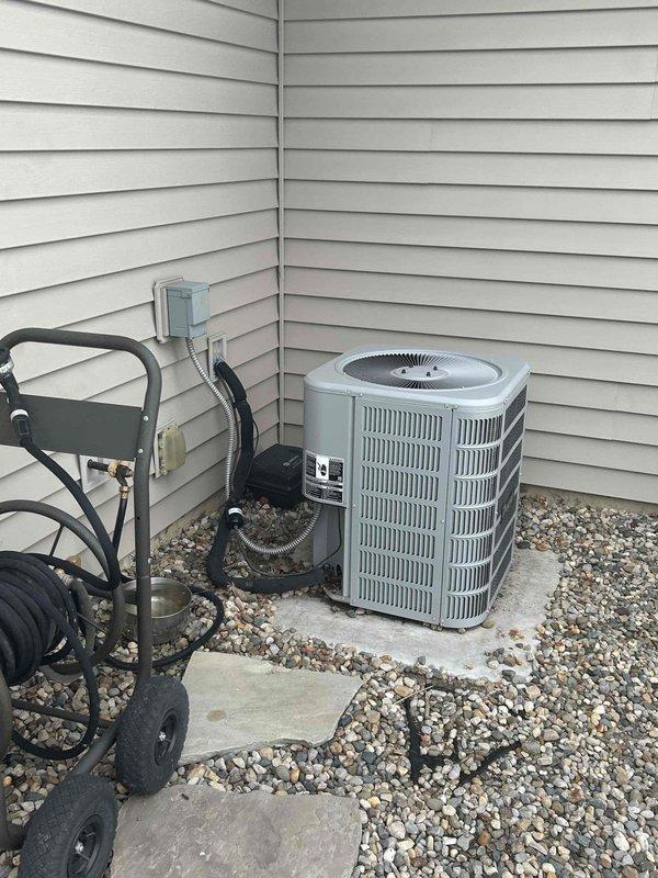 Completed estimate for replacement of air conditioning system and evaporator coil. Assessed existing indoor furnace unit located in garage and outdoor condensing unit, noting mismatched equipment ages between coil and outdoor unit. Documented current system configuration with both indoor and outdoor components, provided replacement recommendations, and photographed existing equipment for proposal documentation.