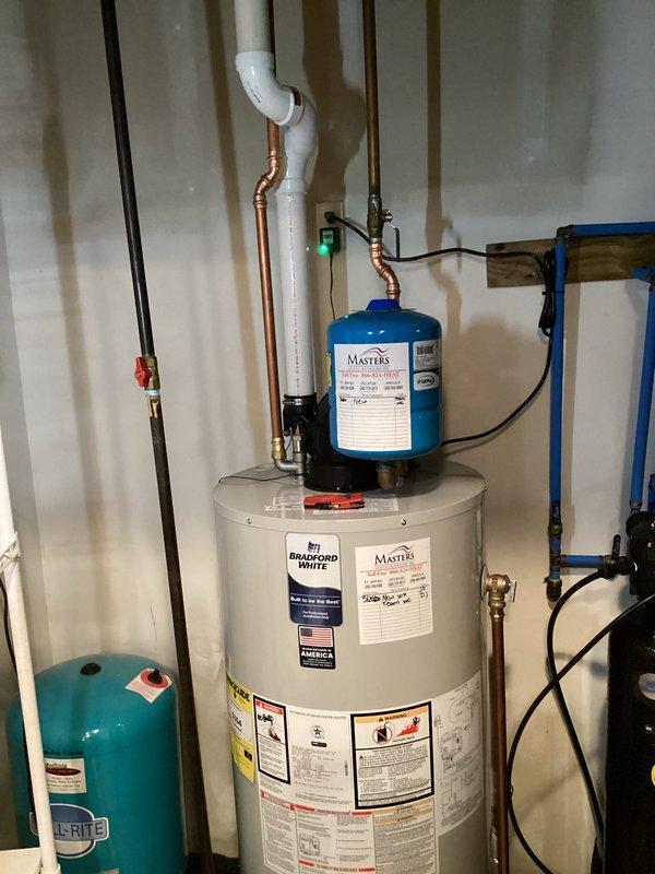 Responded to emergency call for leaking 50-gallon natural gas power vent water heater in basement. Removed and disposed of failed Bradford White unit that had been previously evaluated by other contractors. Installed new 50-gallon natural gas power vent Bradford White water heater with proper venting configuration. Connected all copper supply lines, gas line with appropriate shutoff valve, and installed condensate drain with PVC piping. Verified proper operation of power vent motor and gas control valve. Tested system for leaks, confirmed proper temperature and pressure relief valve operation, and ensured all connections met code requirements. System operational and customer notified upon completion.