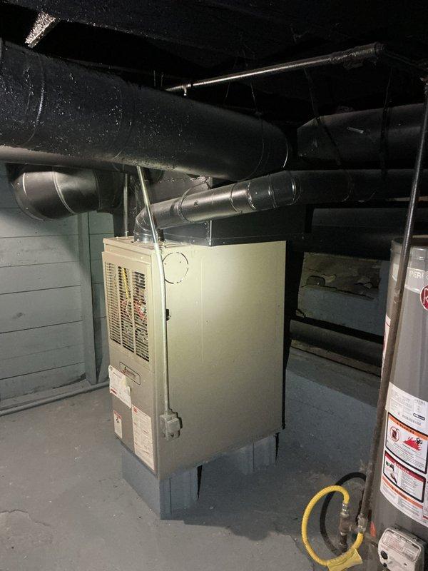 Provided comprehensive estimate for complete air conditioning system replacement at residential property. Existing R-22 system was non-functional due to severed refrigerant line, necessitating full unit replacement rather than repair. Assessed basement-installed furnace and existing ductwork infrastructure to determine compatibility requirements for new AC system. Documented current equipment configuration including plenum connections, condensate drainage routing, and electrical service accessibility. Photographed mechanical room layout showing furnace location, ductwork distribution, water heater proximity, and available workspace for installation. Evaluated attic-mounted evaporator coil access and existing insulation conditions surrounding HVAC components. Reviewed flexible gas line positioning and clearance requirements for safe equipment replacement. Determined specifications for new system sizing based on existing ductwork capacity and home cooling load requirements. Presented equ
