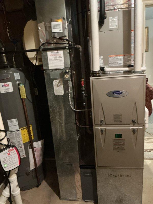 Completed full HVAC system replacement with Carrier Infinity Series equipment including installation of 26VNA136W003 variable-speed air conditioner, CVAVA4217XMA evaporator coil, and 59MN7C080C17-14 modulating gas furnace with up to 98% AFUE efficiency. Installed SYSTXCCITC01-C Infinity System Controller with WiFi capability for communicating system operation. Removed and recycled existing HVAC equipment from basement mechanical room. Reconnected existing supply and return ductwork to new air handler and furnace assembly. Installed outdoor condenser unit on new 2-inch PVC pad with pea gravel base on building exterior. Mounted electrical disconnect box adjacent to condenser for service access. Ran refrigerant lines and electrical connections between indoor and outdoor components. Completed all refrigerant line insulation and secured piping runs. Programmed and configured Infinity thermostat system for optimal variable-speed and modulating operation. Provided thermostat operation explana