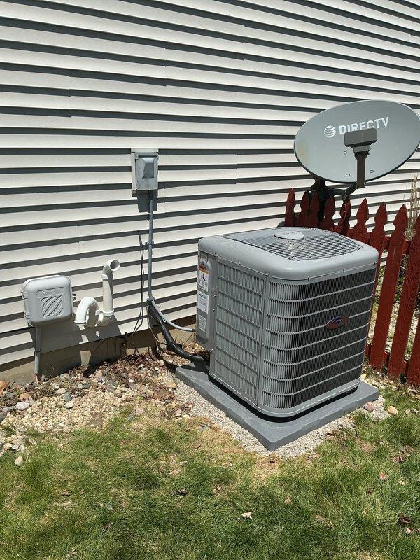 Completed full HVAC system replacement with Carrier Infinity Series equipment including installation of 26VNA136W003 variable-speed air conditioner, CVAVA4217XMA evaporator coil, and 59MN7C080C17-14 modulating gas furnace with up to 98% AFUE efficiency. Installed SYSTXCCITC01-C Infinity System Controller with WiFi capability for communicating system operation. Removed and recycled existing HVAC equipment from basement mechanical room. Reconnected existing supply and return ductwork to new air handler and furnace assembly. Installed outdoor condenser unit on new 2-inch PVC pad with pea gravel base on building exterior. Mounted electrical disconnect box adjacent to condenser for service access. Ran refrigerant lines and electrical connections between indoor and outdoor components. Completed all refrigerant line insulation and secured piping runs. Programmed and configured Infinity thermostat system for optimal variable-speed and modulating operation. Provided thermostat operation explana