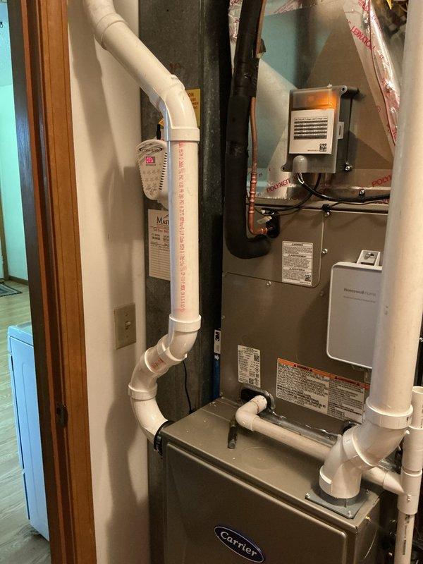 Completed full HVAC system replacement including installation of Carrier 26SCA424N003 single-stage air conditioner, CVAVA3017XMA evaporator coil, and 59TP7A060V17-16 Performance 97 two-stage gas furnace. Removed and recycled existing equipment, reconnected to existing lineset after flushing and pressure testing, and reconnected existing supply and return ductwork. Installed new 2" PVC condenser pad, new disconnect and whip, and completed furnace changeout utilizing installation kit for 80% to 97% efficiency upgrade. Applied floor savers for home protection, obtained necessary permits, and performed post-installation quality assurance walkthrough. Provided system operation explanation and thermostat instruction, registered warranty with manufacturer, and submitted utility rebate paperwork on behalf of customer.