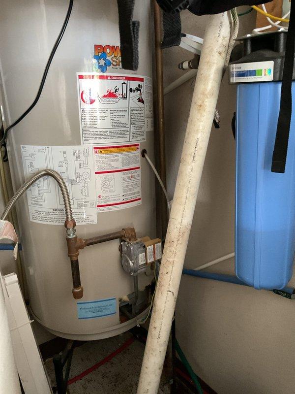Conducted on-site evaluation of existing gas-fired storage tank water heater located in garage utility area for potential replacement with tankless electric water heater system. Assessed current installation including gas supply connections, venting configuration, electrical infrastructure, available clearances, and plumbing connections. Documented existing water heater specifications, sediment filtration system, copper supply piping with flexible connectors, and available space constraints within mechanical room. Provided comprehensive estimate for tankless electric water heater conversion including electrical service upgrade requirements, reconfiguration of water supply lines, and removal of existing gas appliance.