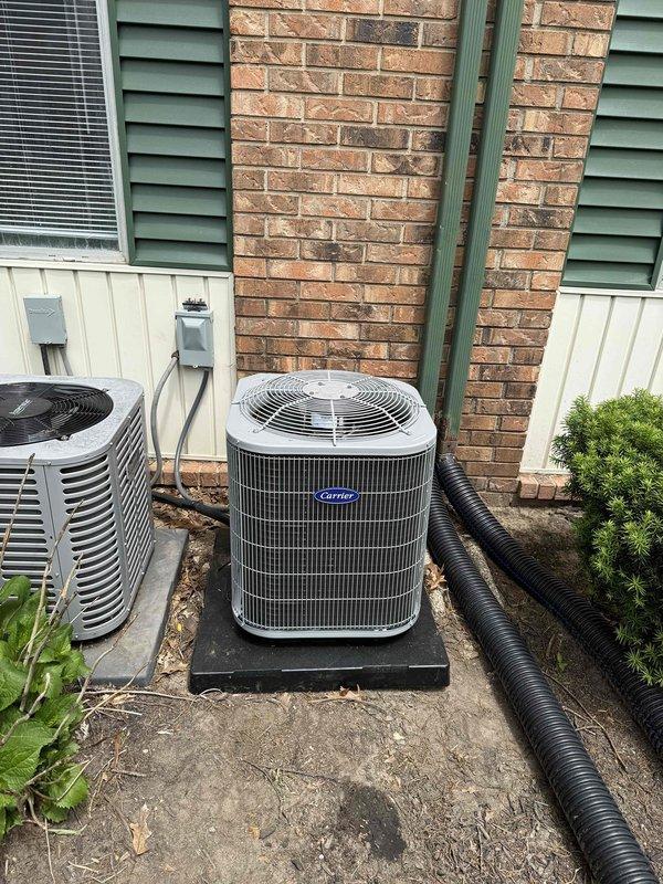 Successfully completed installation of new Carrier air conditioning system with matching evaporator coil. Removed existing outdoor condenser unit and installed new Carrier condensing unit on reinforced composite pad with proper clearances from structure and adjacent equipment. Positioned unit to ensure adequate airflow and service access. Ran new refrigerant line set through exterior wall penetration with appropriate sealing and insulation. Inside mechanical closet, removed old air handler and installed new compatible air handler unit with upflow configuration. Mounted unit securely to floor with proper leveling and vibration isolation. Connected flexible supply duct to top of air handler, routing through ceiling access opening to main distribution system. Installed new pleated air filter in accessible filter rack below air handler for easy maintenance access. Made all electrical connections to air handler including low voltage thermostat wiring and high voltage power supply. Evacuated