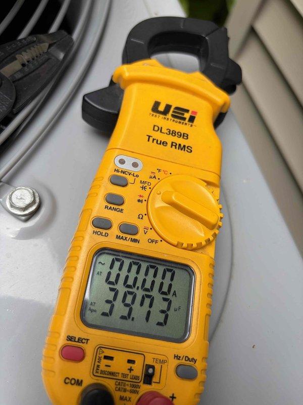 Performed routine maintenance inspection on residential cooling system. Verified electrical connections at contactor assembly, confirming proper wire termination and secure mounting of all conductors. Measured and recorded system amperage draw using clamp meter, with readings indicating normal operating parameters at 40.00A and 39.73A, confirming compressor is functioning within manufacturer specifications.
