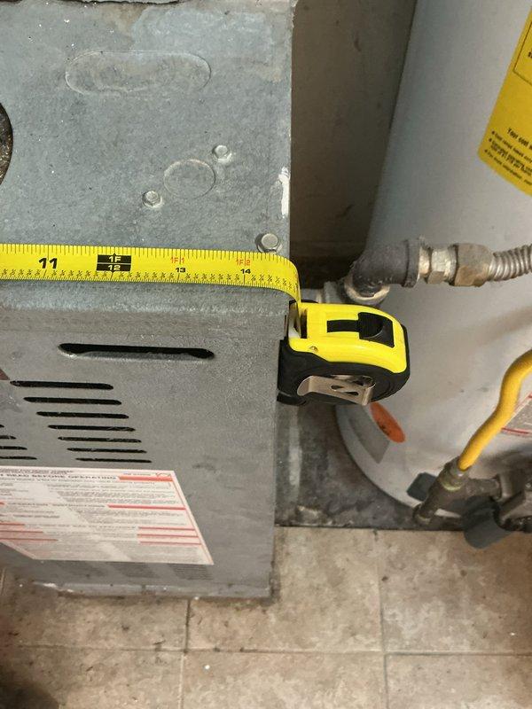 Conducted comprehensive evaluation of existing 30+ year old gas furnace and air conditioning system for replacement estimate. Assessed current equipment condition, measured existing furnace dimensions and clearances in mechanical room, documented installation configuration including ductwork connections and utilities. Photographed aging HVAC equipment to support replacement recommendations and verify proper sizing requirements for new system installation.