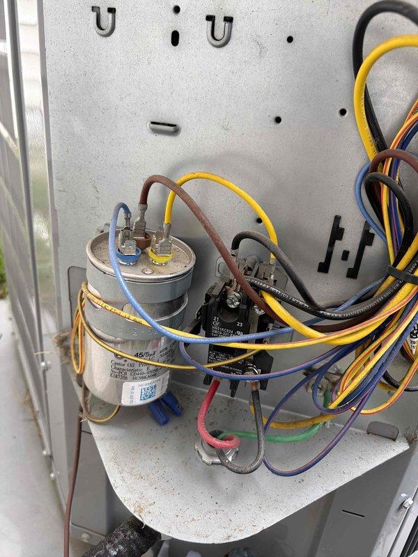Completed routine air conditioning maintenance on Carrier outdoor condensing unit. Inspected electrical components including capacitor, contactor, and wiring connections within control panel, verifying all connections were secure and components functioning properly. Verified system operation and confirmed unit is operating within normal parameters through end of current maintenance agreement period.