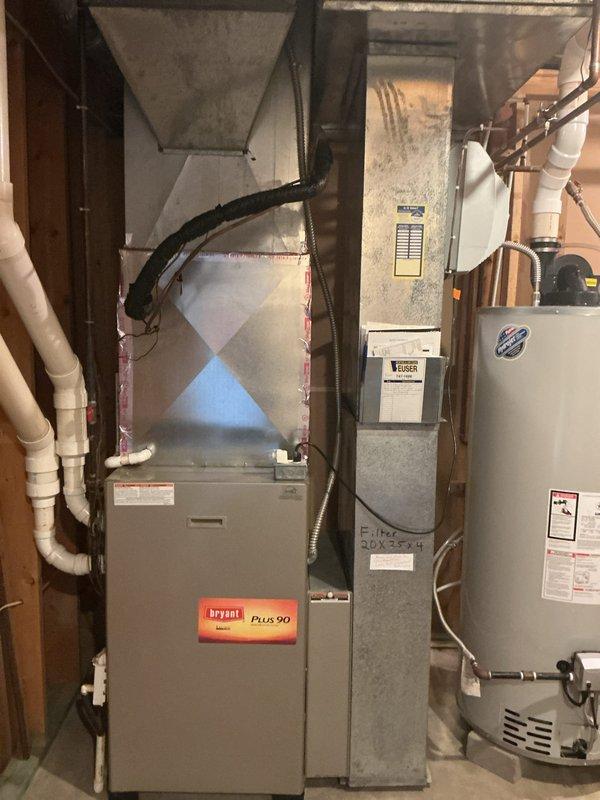 Conducted on-site assessment of existing HVAC system to provide replacement estimates for a Bryant Plus 90 furnace and optional air conditioning unit. Documented current equipment configuration including furnace, air handler, and associated ductwork in basement utility area. Photographed existing installation showing PVC condensate drainage, plenum connections, and filter specifications (20X25X4) to develop accurate replacement proposals for both furnace-only and complete system replacement options.