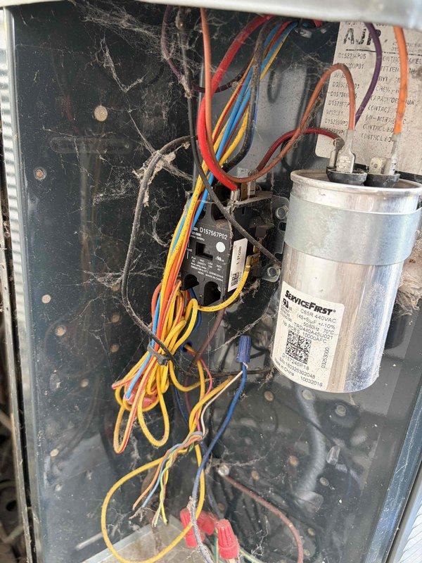 Completed final prepaid cooling system maintenance visit on residential air conditioning unit. Performed comprehensive inspection of electrical components, capacitor, and control panel within HVAC system housing. All components found to be operating within normal parameters, with capacitor connections secure and electrical wiring properly routed. System tested and confirmed ready for upcoming cooling season.