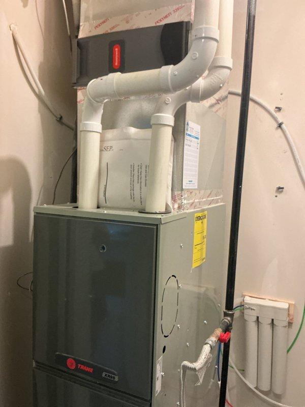 Completed comprehensive estimate for HVAC system replacement following identification of cracked heat exchanger and failing bearings in existing equipment. Assessed current Trane furnace installation and air conditioning system in utility room, documenting existing configuration including PVC condensate drainage, electrical connections, and mechanical layout. Provided detailed replacement options and specifications for new gas furnace and air conditioning system to address critical safety concerns with compromised heat exchanger and mechanical failure of bearing components.