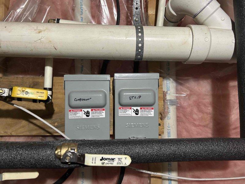 Responded to no-cool condition on geothermal system with failed compressor and refrigerant leak. Provided estimate for complete HVAC system replacement, evaluating both geothermal and traditional split system options as alternatives to existing WaterFurnace unit. Documented current installation including EcoLink equipment, electrical disconnects for condenser and auxiliary heat strips, refrigerant lines with service valves, and associated plumbing components in basement mechanical room.