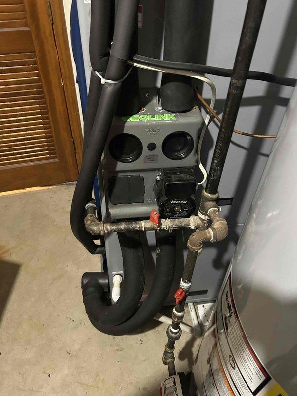 Responded to no-cool condition on geothermal system with failed compressor and refrigerant leak. Provided estimate for complete HVAC system replacement, evaluating both geothermal and traditional split system options as alternatives to existing WaterFurnace unit. Documented current installation including EcoLink equipment, electrical disconnects for condenser and auxiliary heat strips, refrigerant lines with service valves, and associated plumbing components in basement mechanical room.
