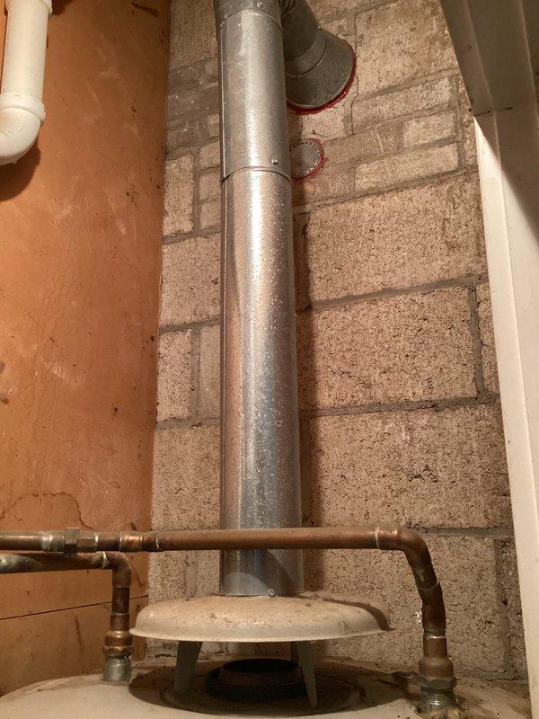 Responded to service call for leaking gas tanked water heater located in interior closet. Upon arrival, inspected A.O. Smith brand gas water heater and associated plumbing connections. Identified active leak at base of unit with visible water damage and staining on concrete floor surrounding tank. Evaluated copper supply lines, brass shut-off valves, and vent flue system for proper installation and functionality. Documented condition of unit, plumbing connections, electrical junction box, and venting configuration through photographic evidence. Based on age of unit, extent of tank corrosion, and severity of leak, recommended full water heater replacement as repair would not be cost-effective or reliable long-term solution.