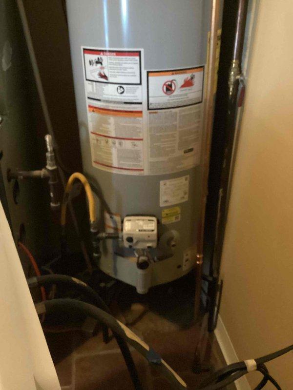 Responded to no hot water complaint on A.O. Smith 40-gallon natural gas water heater (Model GCR-40 410) installed in main floor utility closet. Upon arrival, confirmed unit had shut off with no pilot light indication. Inspected gas control valve, thermocouple, and pilot assembly. Relit pilot light, verified proper flame characteristics, and tested burner operation through full heating cycle. Confirmed hot water restoration and proper unit function before departure.