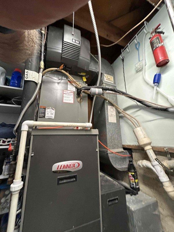 Conducted on-site assessment for complete HVAC system replacement, evaluating existing Lennox gas furnace and air conditioning equipment located in basement utility area. Documented current installation configuration including air handler, refrigerant lines, PVC condensate drainage, and electrical connections. Additionally evaluated existing tank-style water heater for potential tankless water heater conversion, noting current venting arrangement and gas supply infrastructure to provide comprehensive replacement quotes for both HVAC system and water heating equipment.
