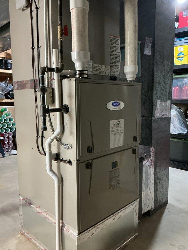 Completed full HVAC system replacement including installation of Carrier 26TPA860W003 Performance Series two-stage air conditioner, Carrier CVAVA6024XMA evaporator coil, and Carrier 59TN7A120C24-22 Infinity Series two-stage gas furnace with limited lifetime heat exchanger warranty. Installed Honeywell Elite Pro S1200 thermostat and Honeywell F100F2025 4-inch media air cleaner for improved indoor air quality. Removed and properly recycled existing equipment, reconnected all supply and return ductwork to new system, installed new electrical disconnect and whip for outdoor unit, and provided floor protection throughout installation area. Verified all electrical connections, gas line connections, refrigerant charge, and system operation including two-stage heating and cooling functionality. Conducted complete system startup, programmed thermostat settings, and performed post-installation quality assurance walkthrough with senior technician to ensure proper operation and customer satisfacti