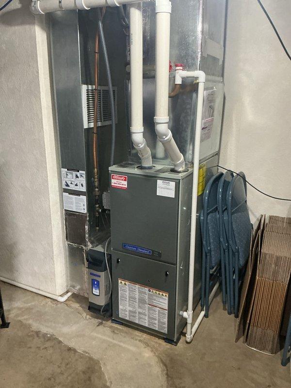 Conducted comprehensive estimate for complete air conditioning system and evaporator coil replacement versus repair options on existing HVAC system with basement furnace installation. Evaluated current equipment configuration including gray furnace unit, dark air handler cabinet, copper refrigerant lines, and white PVC ventilation piping to determine replacement specifications. Assessed thermostat functionality, existing ductwork connections, electrical disconnect requirements, and drainage system compatibility for new equipment installation, providing homeowner with detailed comparison between repair and full system replacement options.