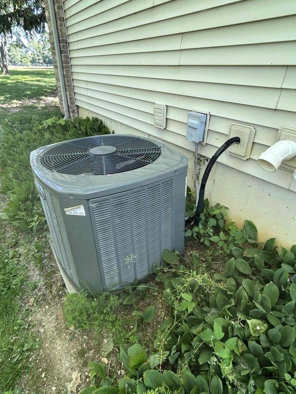 Conducted comprehensive HVAC system evaluation for equipment replacement estimate. Assessed existing exterior condensing unit and interior ductwork infrastructure, documenting current system configuration including refrigerant line routing, electrical connections, and structural considerations. Evaluated ceiling-mounted distribution system with exposed ductwork and identified wall-mounted service disconnects and drainage components for replacement planning purposes.