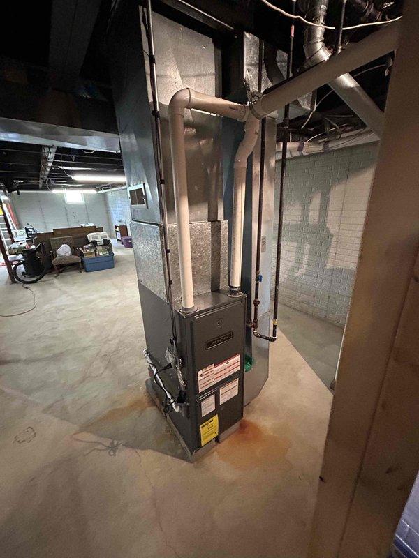 Completed on-site assessment for residential air conditioning system replacement. Evaluated existing HVAC equipment installation in basement mechanical room, including furnace and air handler configuration. Documented current system layout, clearance measurements, and spatial constraints for proposed equipment replacement. Assessed ductwork connections, refrigerant line routing, and condensate drainage pathways. Photographed existing installation showing equipment positioning on concrete floor, PVC drainage piping, metal ductwork plenum, and flexible refrigerant lines. Verified available space for new equipment installation and identified necessary modifications to accommodate replacement system. Provided comprehensive estimate for complete air conditioning system replacement to restore cooling functionality.