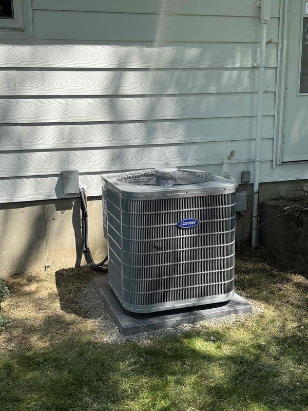 Completed full HVAC system installation including Carrier 26SPA624W003 Performance Series single-stage air conditioner and Carrier CVAVA3017XMA evaporator coil. Removed and properly recycled existing equipment. Installed new refrigerant line set connecting outdoor condensing unit to indoor evaporator coil. Mounted condensing unit on new 2-inch PVC pad with pea gravel base for proper drainage and stability. Installed new electrical disconnect box and whip for code-compliant power supply to outdoor unit. Upgraded thermostat to Honeywell ElitePRO S1200 intelligent control system with equipment interface module for enhanced system management and remote access capabilities. Registered equipment warranty with manufacturer per requirements. Conducted complete system startup, verified proper refrigerant charge, confirmed adequate airflow across evaporator coil, and tested all operational modes. Performed post-installation quality assurance inspection by senior technician to ensure proper insta
