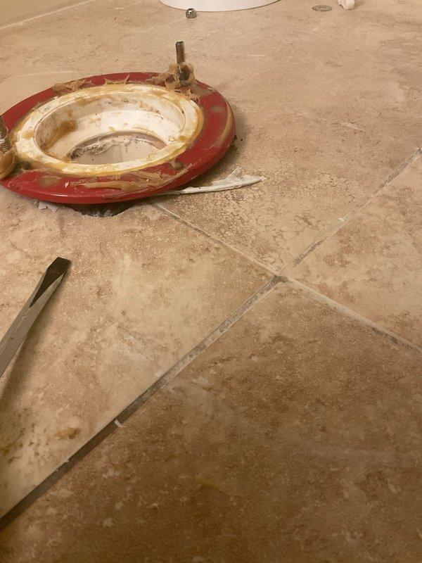 Responded to service call for previously installed commercial toilet with loose floor seal causing rocking movement. Removed toilet, replaced failed wax ring seal and toilet flange components, reset toilet with proper bolting, and verified stable installation with no movement or leakage.