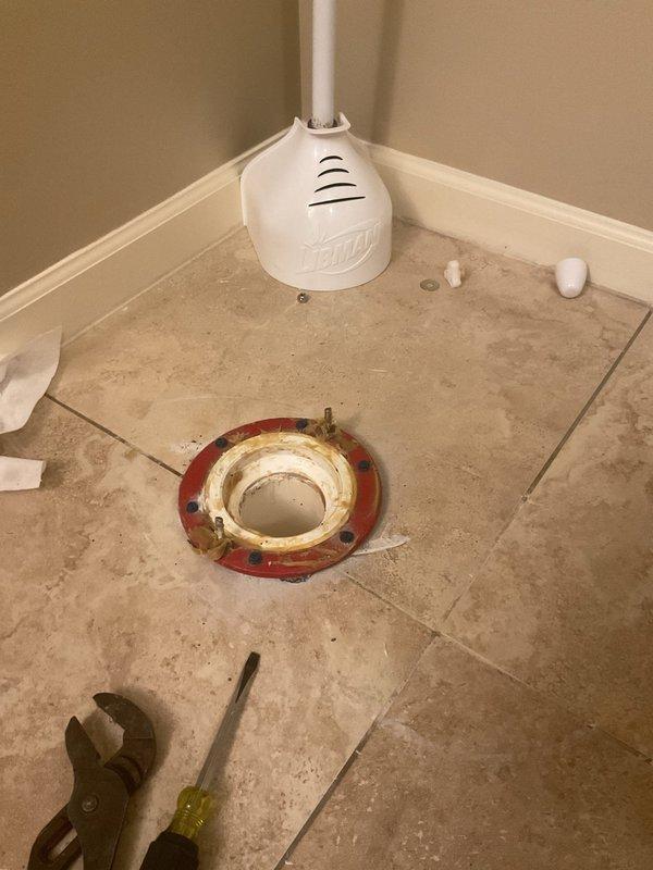 Responded to service call for previously installed commercial toilet with loose floor seal causing rocking movement. Removed toilet, replaced failed wax ring seal and toilet flange components, reset toilet with proper bolting, and verified stable installation with no movement or leakage.