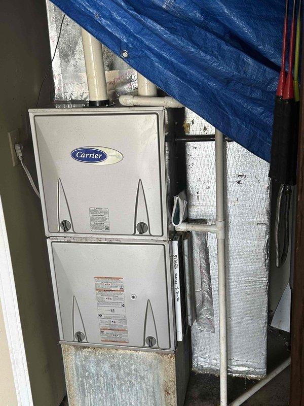 Performed counter sales consultation and provided technical guidance for HVAC system installation. Documented existing Carrier HVAC equipment configuration including stacked unit positioning, PVC condensate drain line routing with measurements, and mechanical space layout with reflective insulation barriers. Captured reference photos showing pipe dimensions, clearances, and component accessibility for planning purposes.