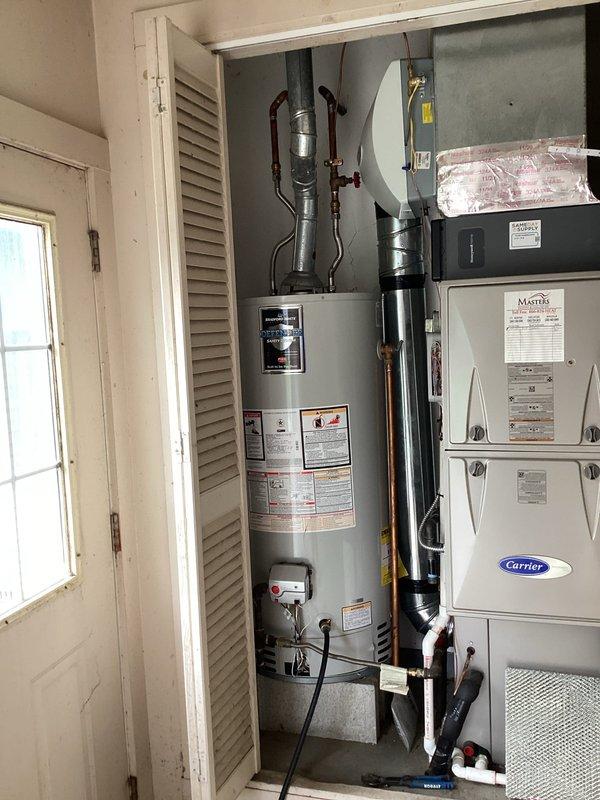 Performed complete maintenance flush on 40-gallon Bradford White tanked gas water heater located in garage utility closet. Drained sediment buildup from tank, inspected temperature and pressure relief valve, verified proper operation of gas control valve and burner assembly, checked all copper water line connections and shutoff valves for leaks, and refilled unit to restore hot water service. All components found functioning within normal parameters upon completion of routine maintenance service.