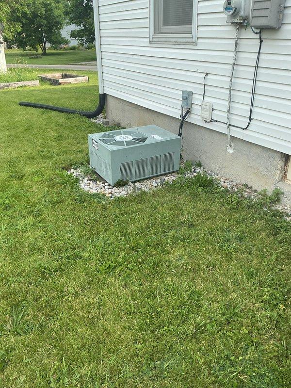 Conducted on-site evaluation for complete HVAC system replacement at residential property with non-operational air conditioning unit. Assessed existing split system consisting of outdoor condensing unit and gas furnace located in basement. Documented current equipment configuration including exterior condenser unit positioned on concrete pad with electrical service and conduit routing. Measured basement structural components and clearances to determine installation requirements for replacement furnace equipment. Provided comprehensive estimate for new air conditioning and heating system replacement.