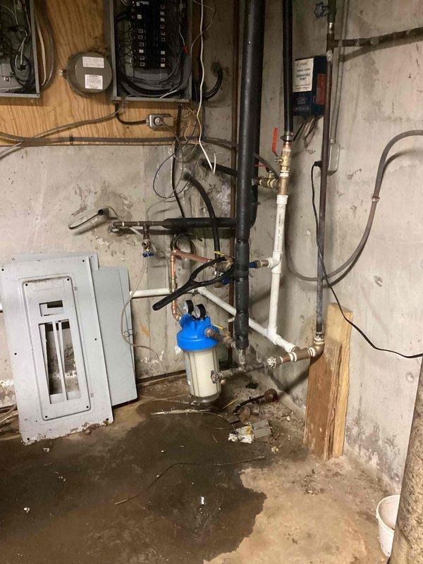 Installed a new 50-gallon Bradford White electric water heater to replace existing unit, including all necessary copper piping connections, pressure relief valve, and shut-off valves. Integrated a whole house water filtration system with blue pressure tank into the main water supply line, utilizing PVC and copper pipe connections with appropriate fittings and isolation valves. Completed all electrical connections to code and tested system for proper operation and leak-free performance.